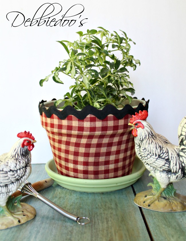 Mod podge terra cotta pots with fabric and a vintage recipe book 020