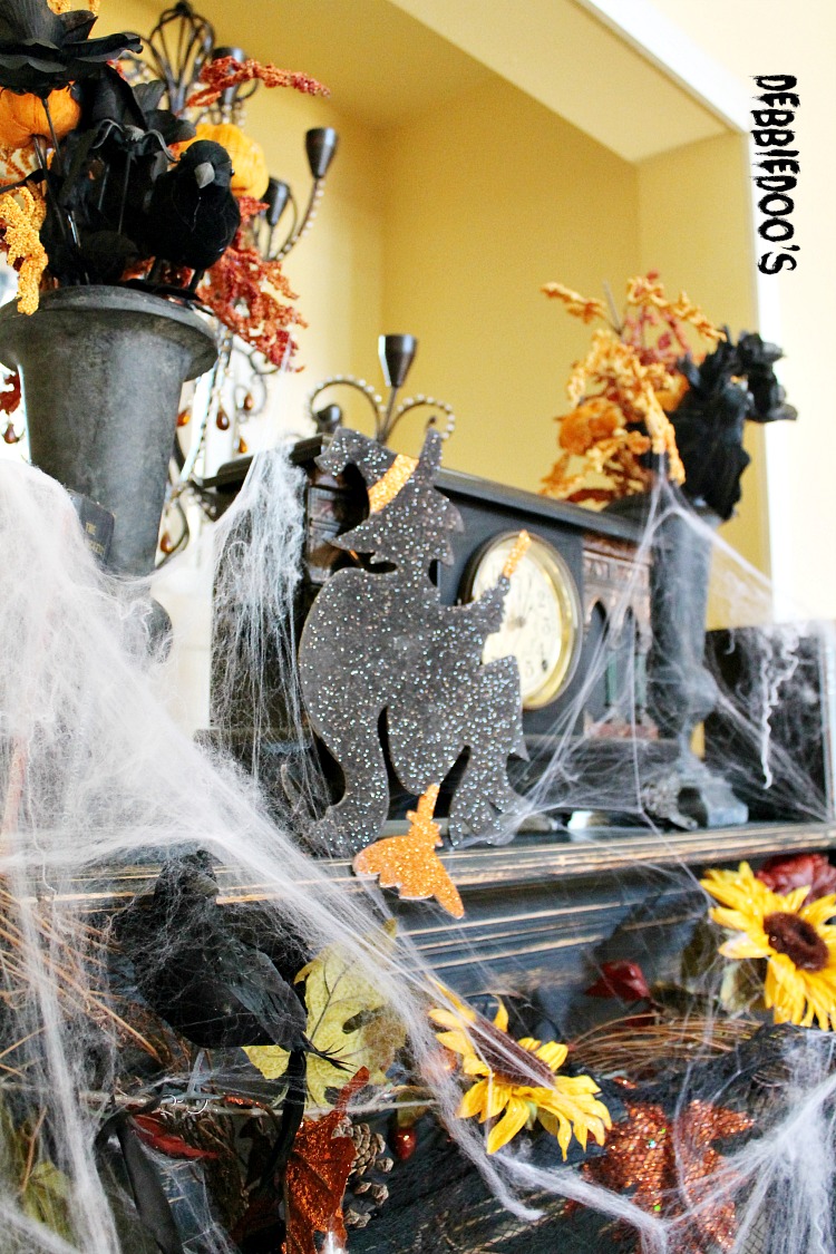 Halloween mantel with crows sunflowers and witches