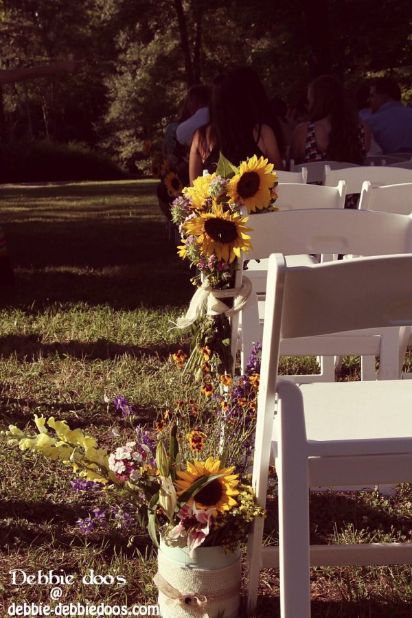 Wedding set up with flowers tied to the end of chairs