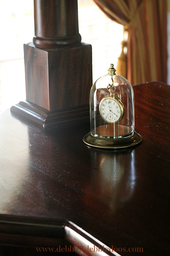 vintage pocket watch under glass dome cloche