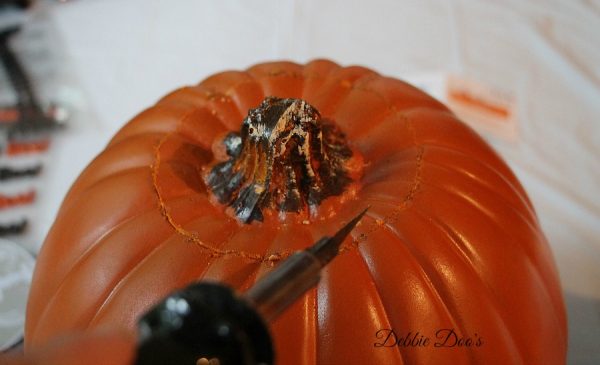 Carving a pumpkin with a hot knife