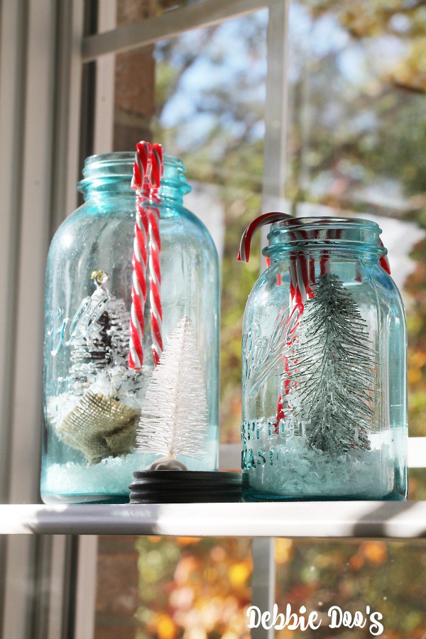 Blue ball mason jars filled with Christmas trees