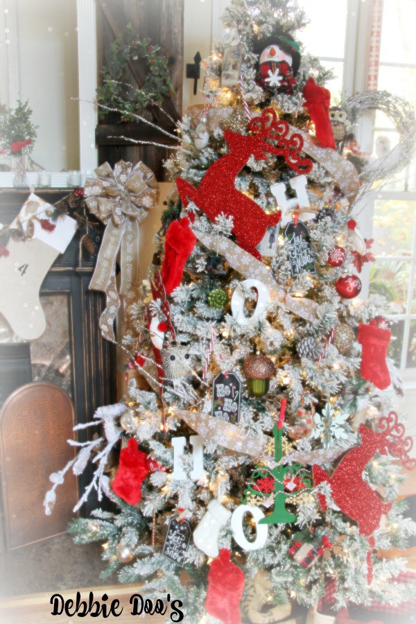 Ho ho ho Merry Christmas festive flocked tree with reds and white and burlap garland