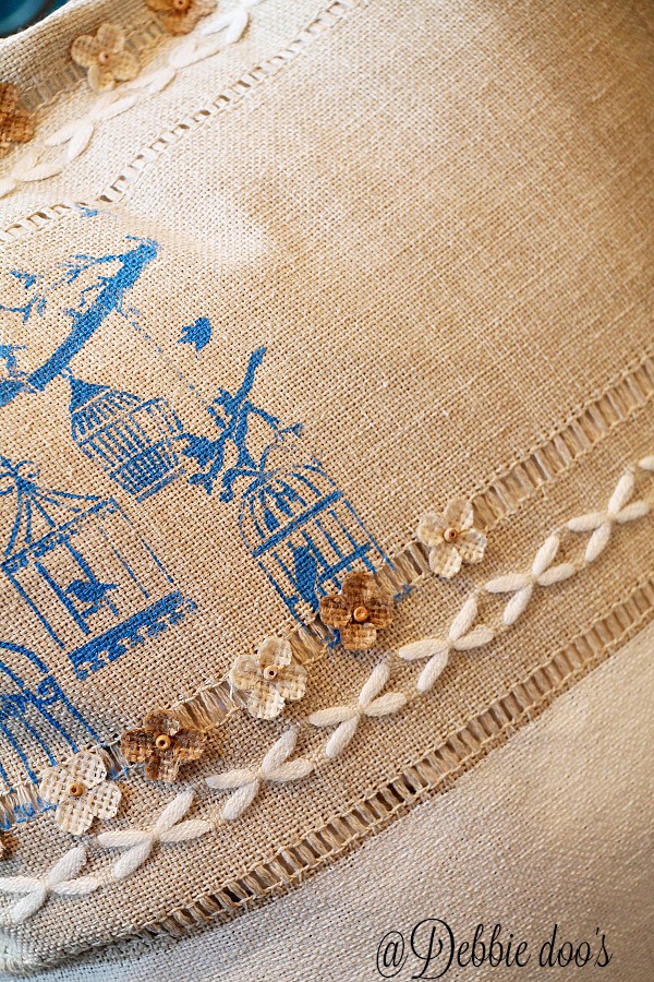 Burlap spring pillow idea with stencils and mini flower embellishments
