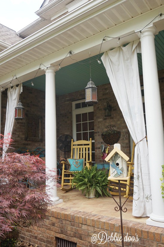 Porch with drop cloth curtains