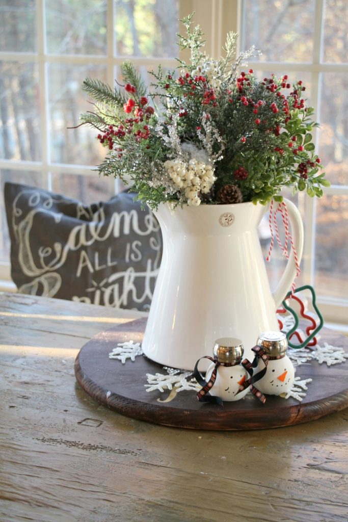 white-pitcher-filled-with-christmas-sprigs-for-the-kitchen-table